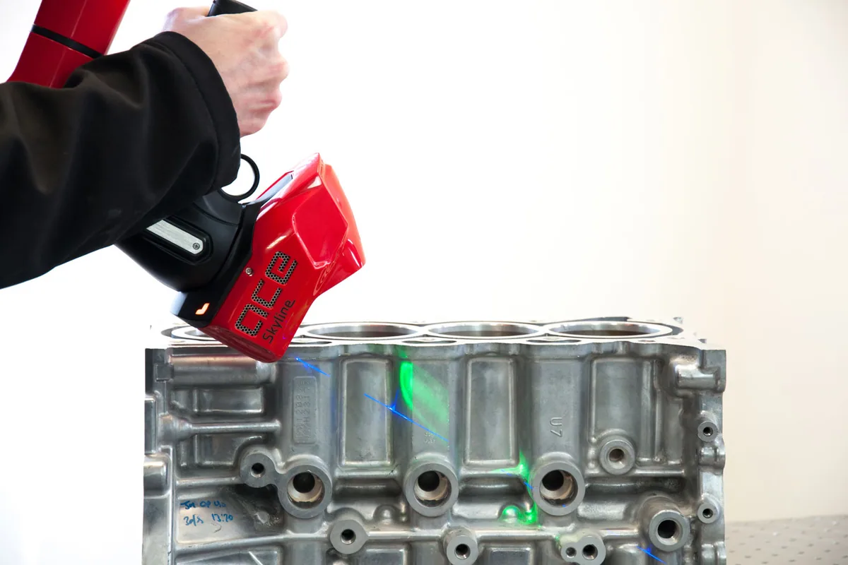 Engine block being scanned in place with a measuring arm